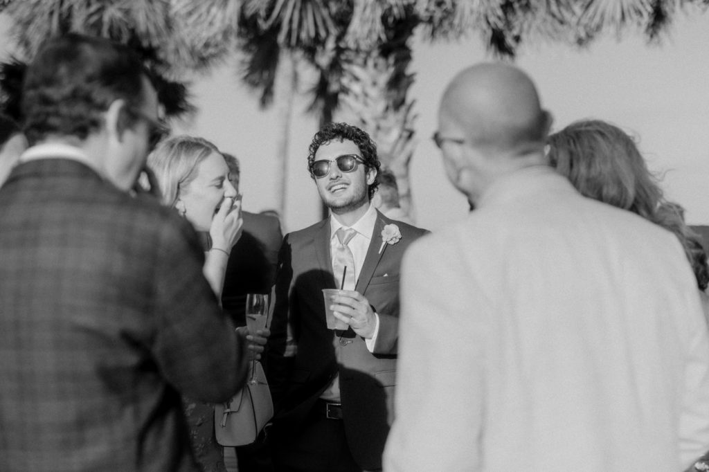 guests laughing at cocktail hour for hilton head beach wedding
