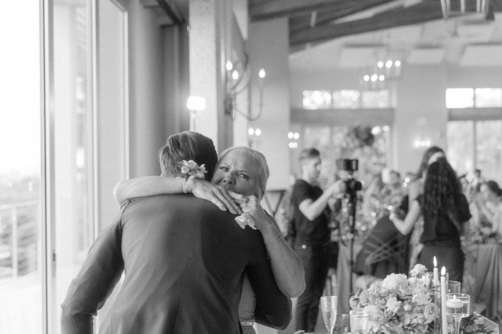 mother hugs groom during parent dances at wedding 