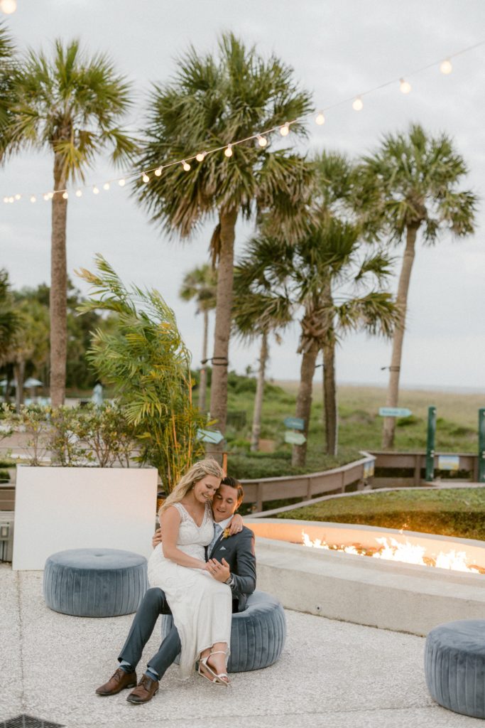 a couple sits in front of fire at wedding for hilton head beach wedding 