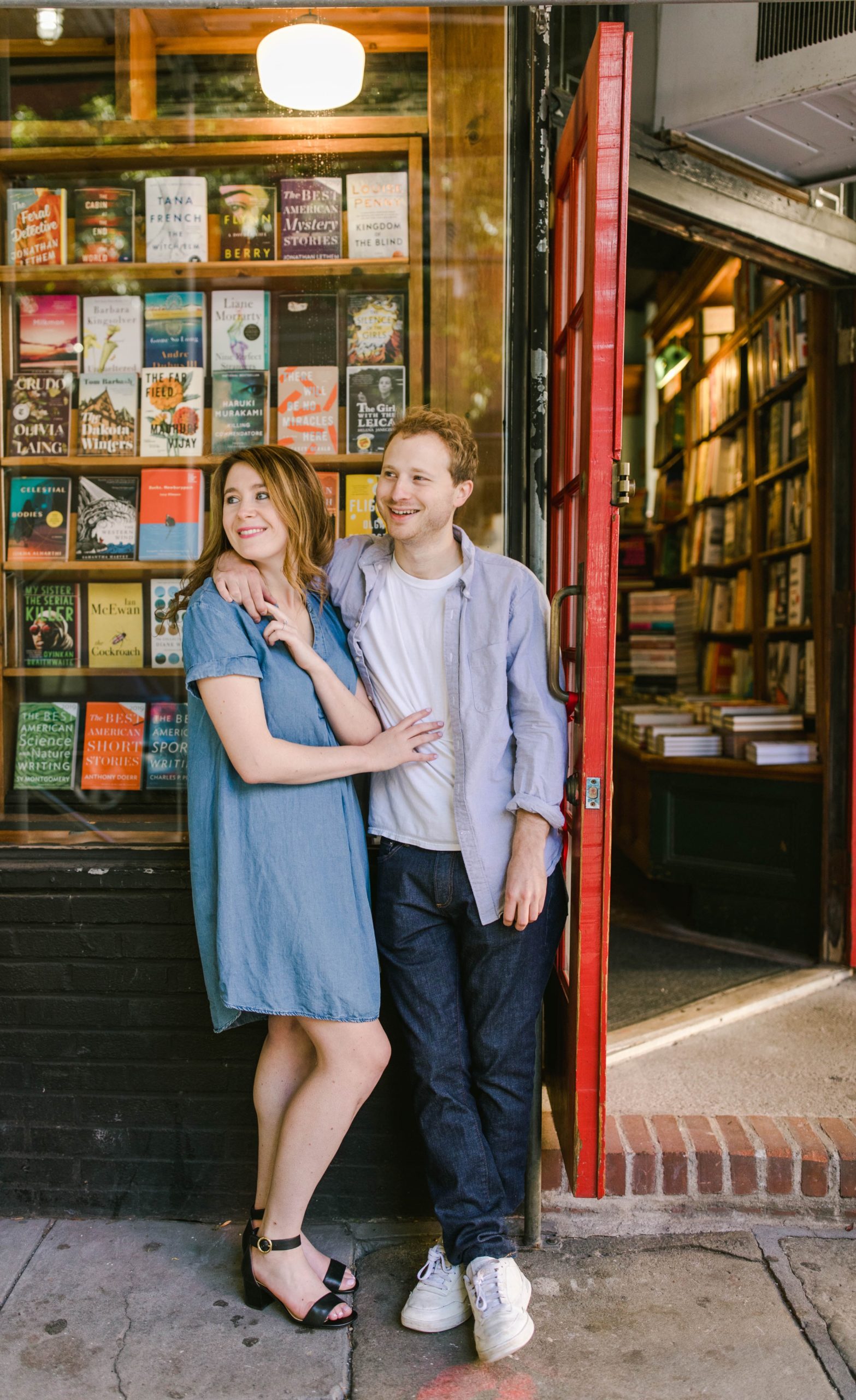 a couple standing beside bookstore in west village