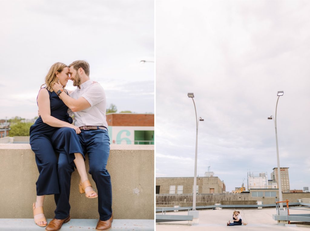 a couple sit on rooftop garage for engagement photos 