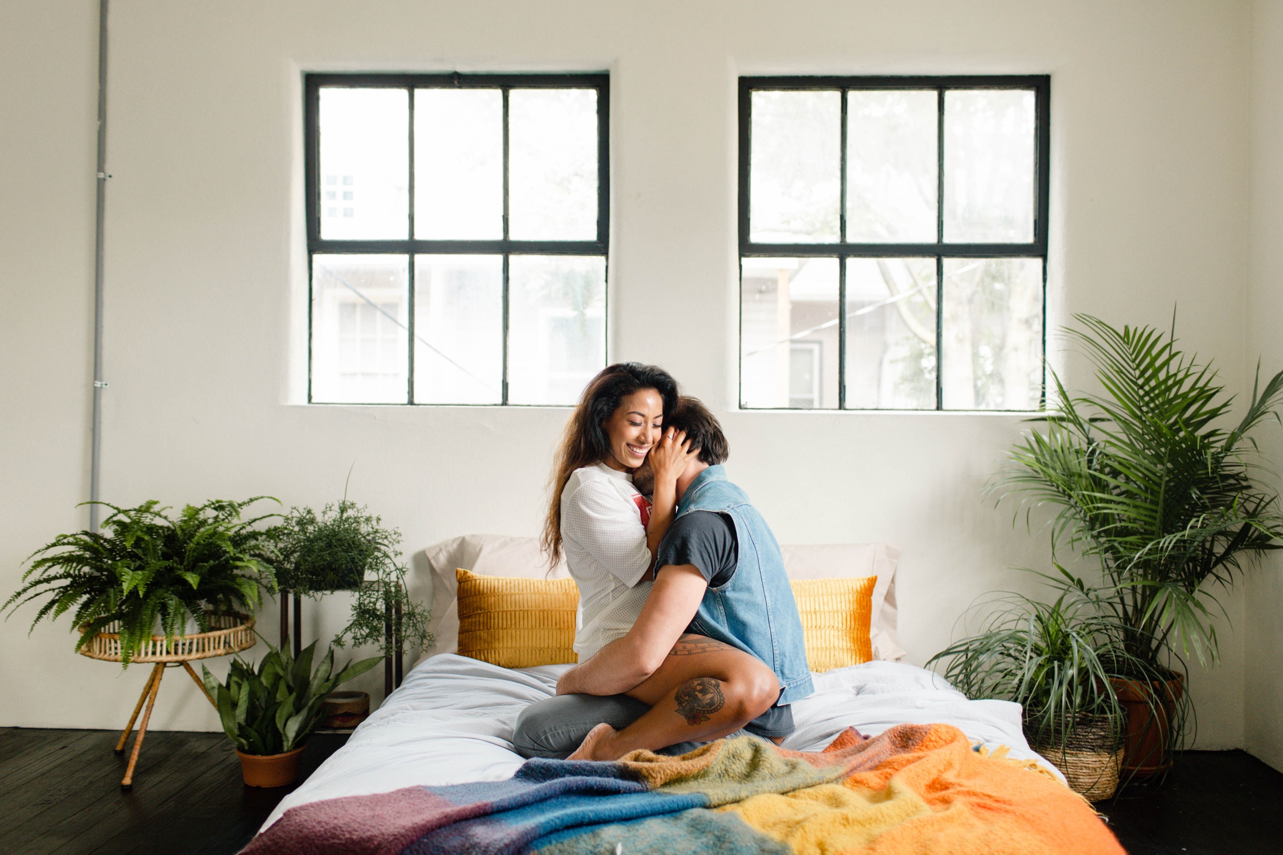 couple laughing and hugging on bed