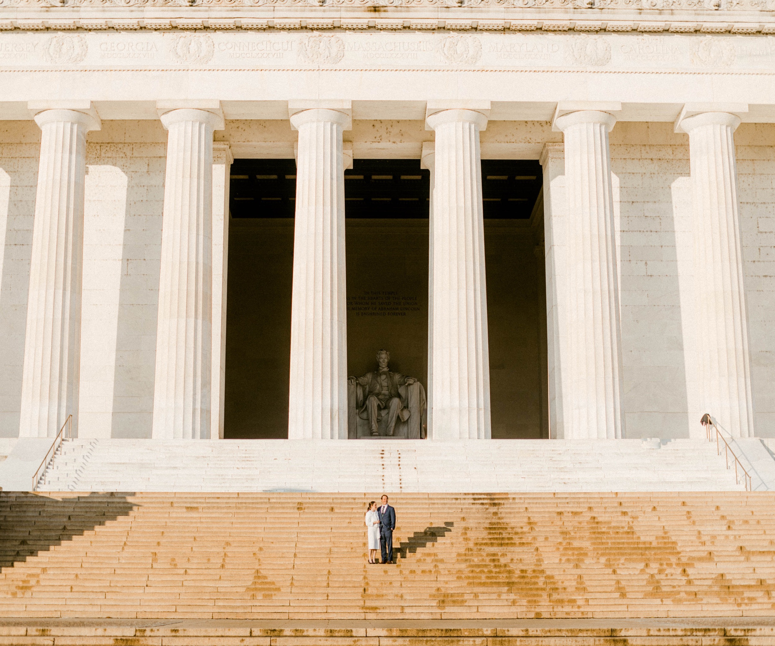 couple standing on steps of lincoln memorial