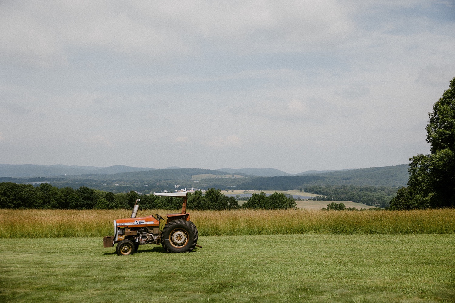 tractor on farm with mountain view