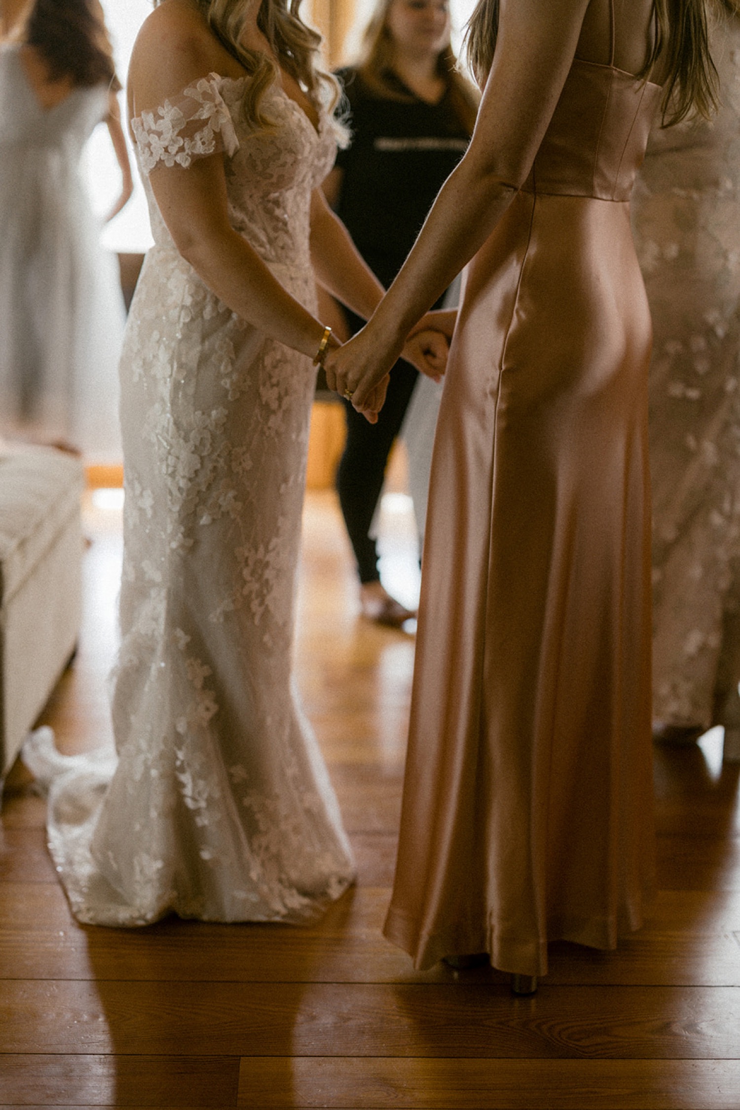 bride holding hands with sister