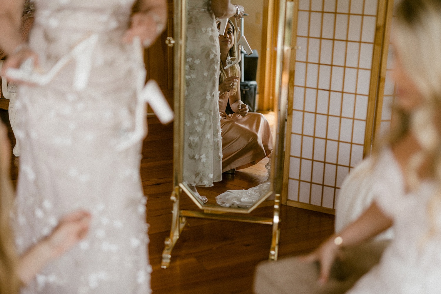 getting ready wedding bride putting on shoes mirror