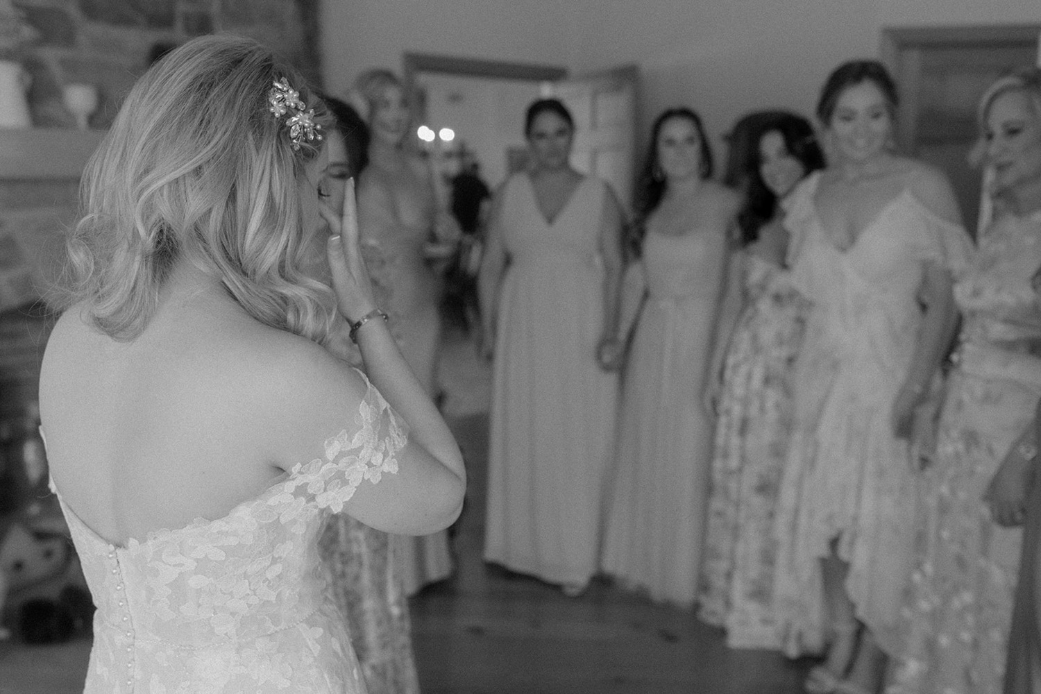 bridesmaids reaction to bride in wedding dress bride crying