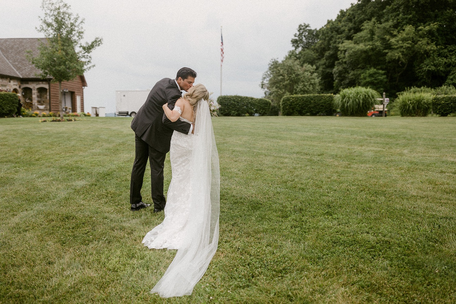 couple kissing at wedding on farm