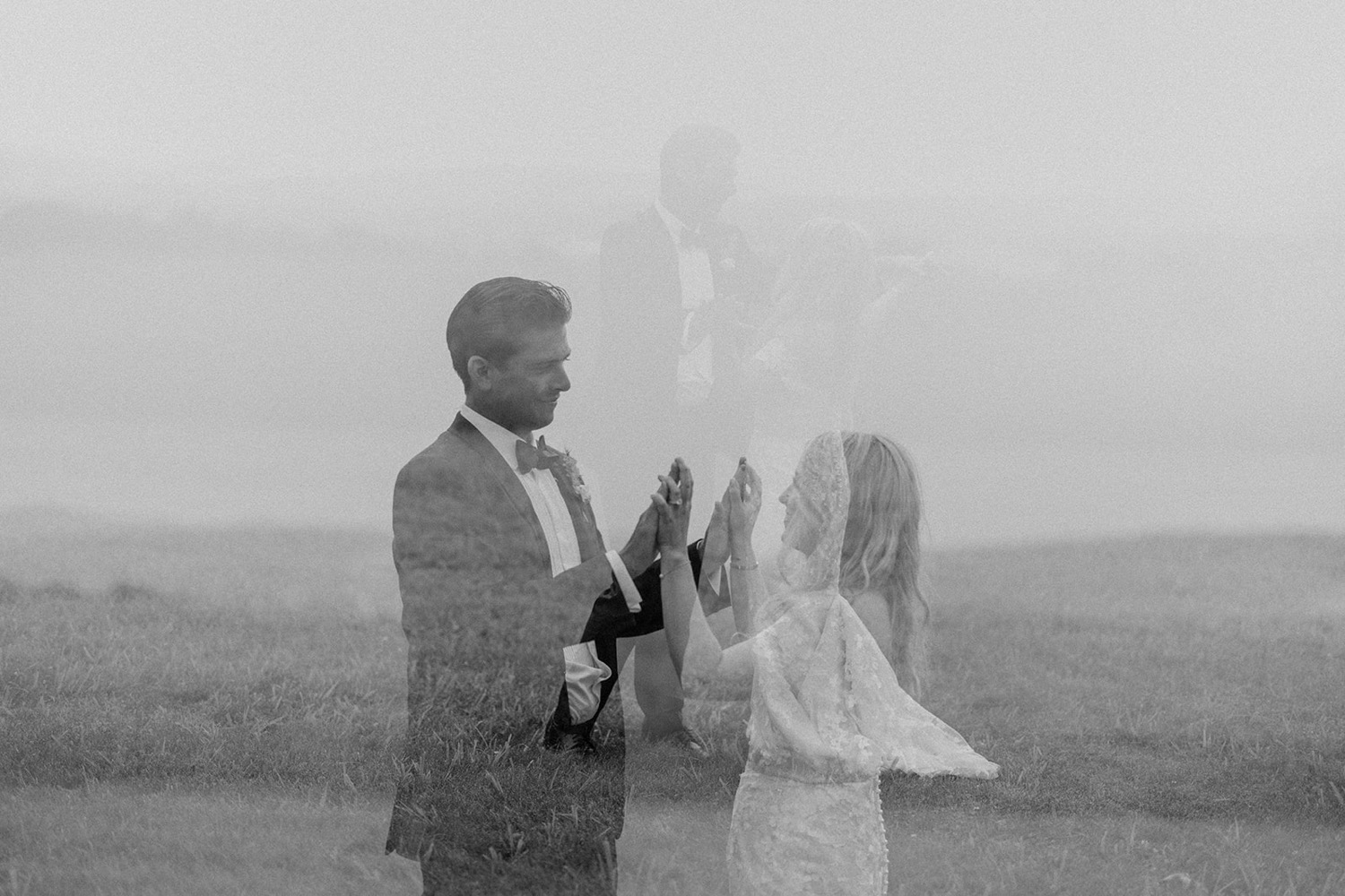 couple holding hands in field at wedding