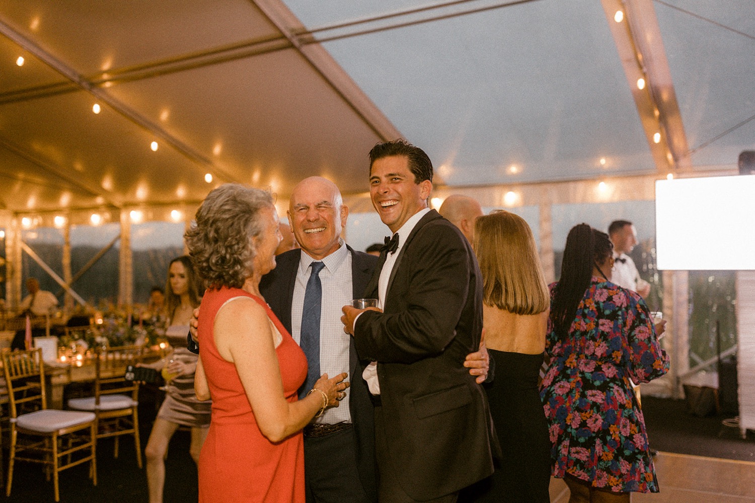group laughing at wedding reception
