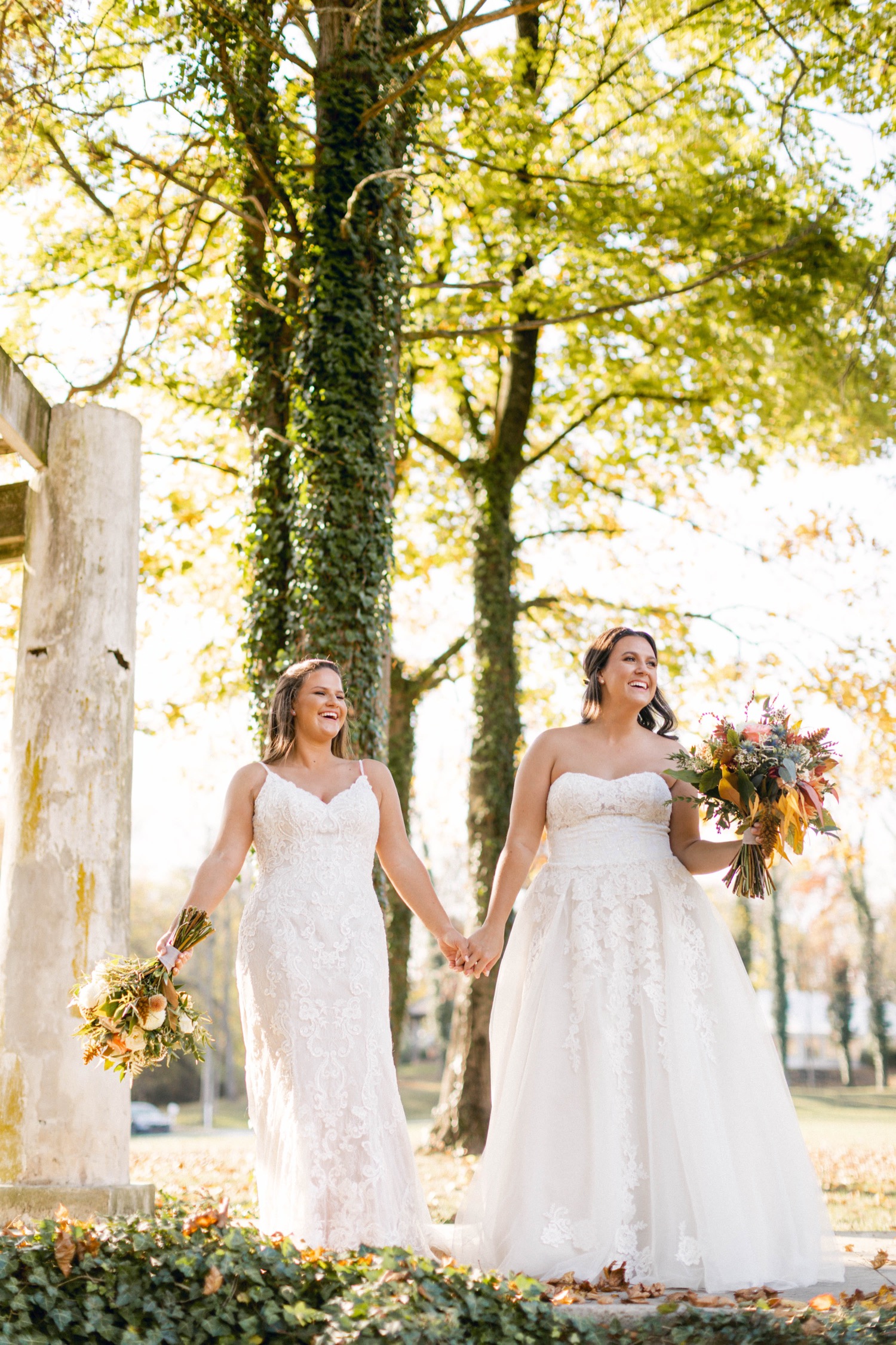 brides with fall bouquets in woodsy outdoor wedding