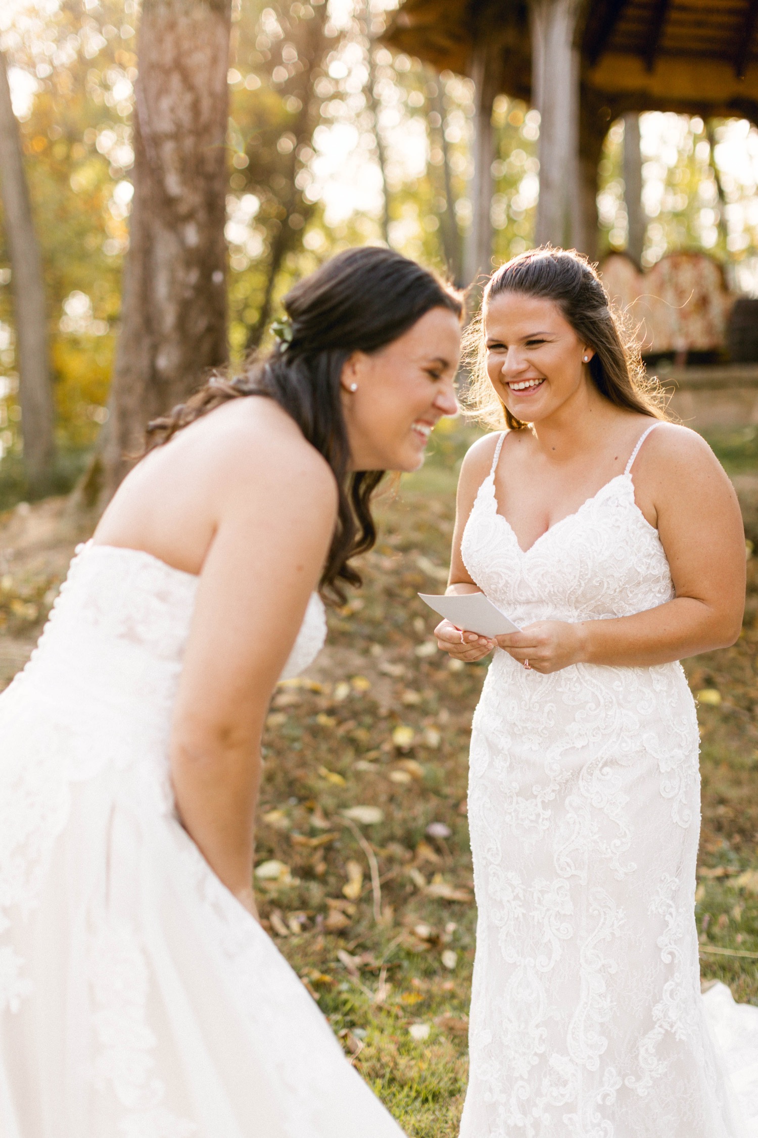 outdoor woodsy fall wedding brides reading vows laughing