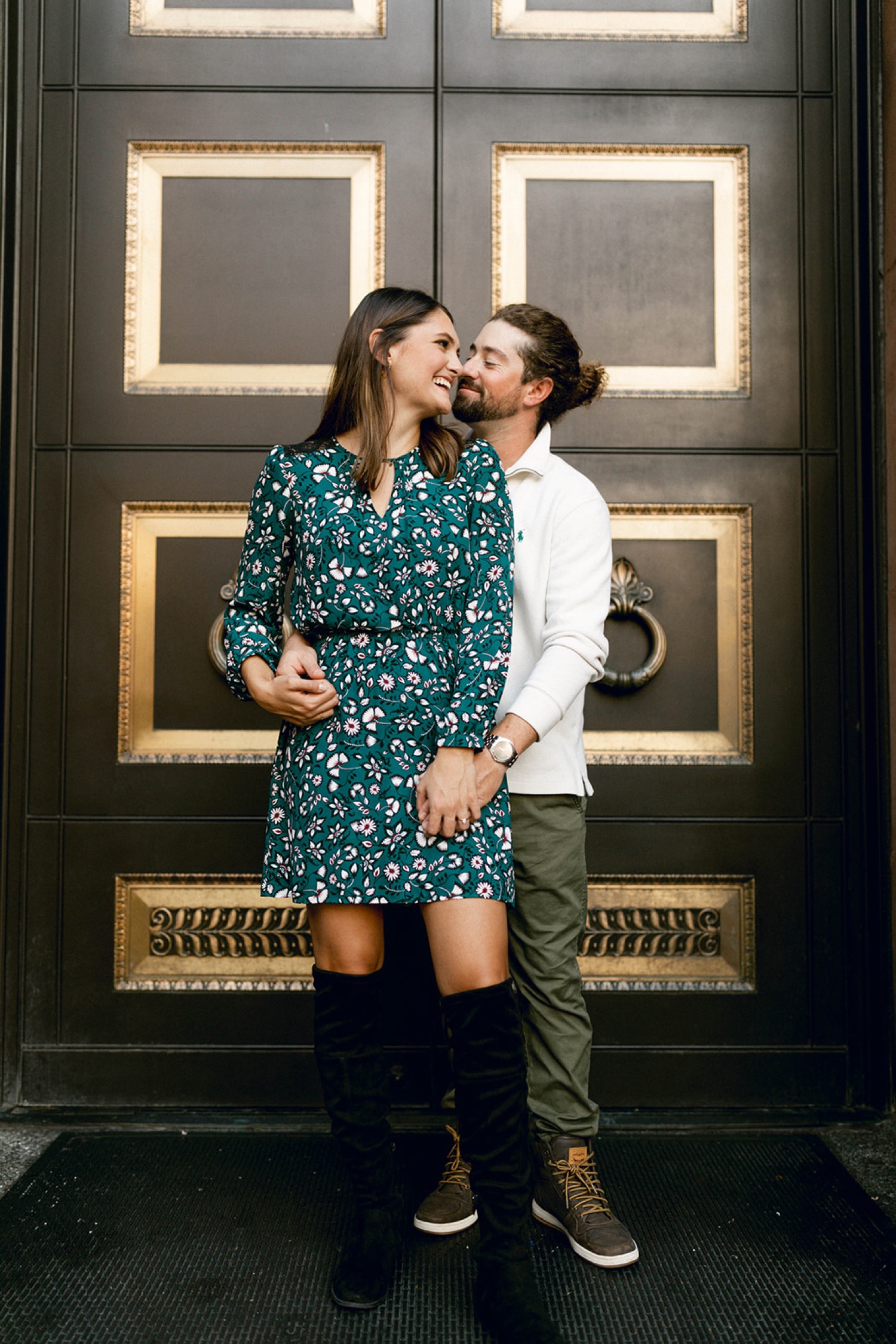 couple kissing in front of black door