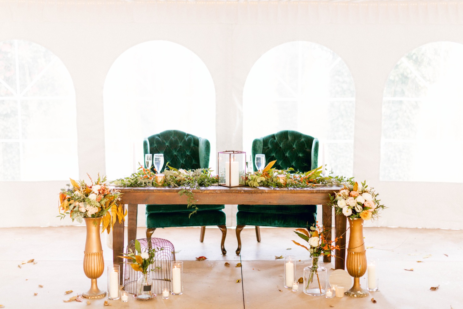wedding head table with autumn flowers and teal chairs