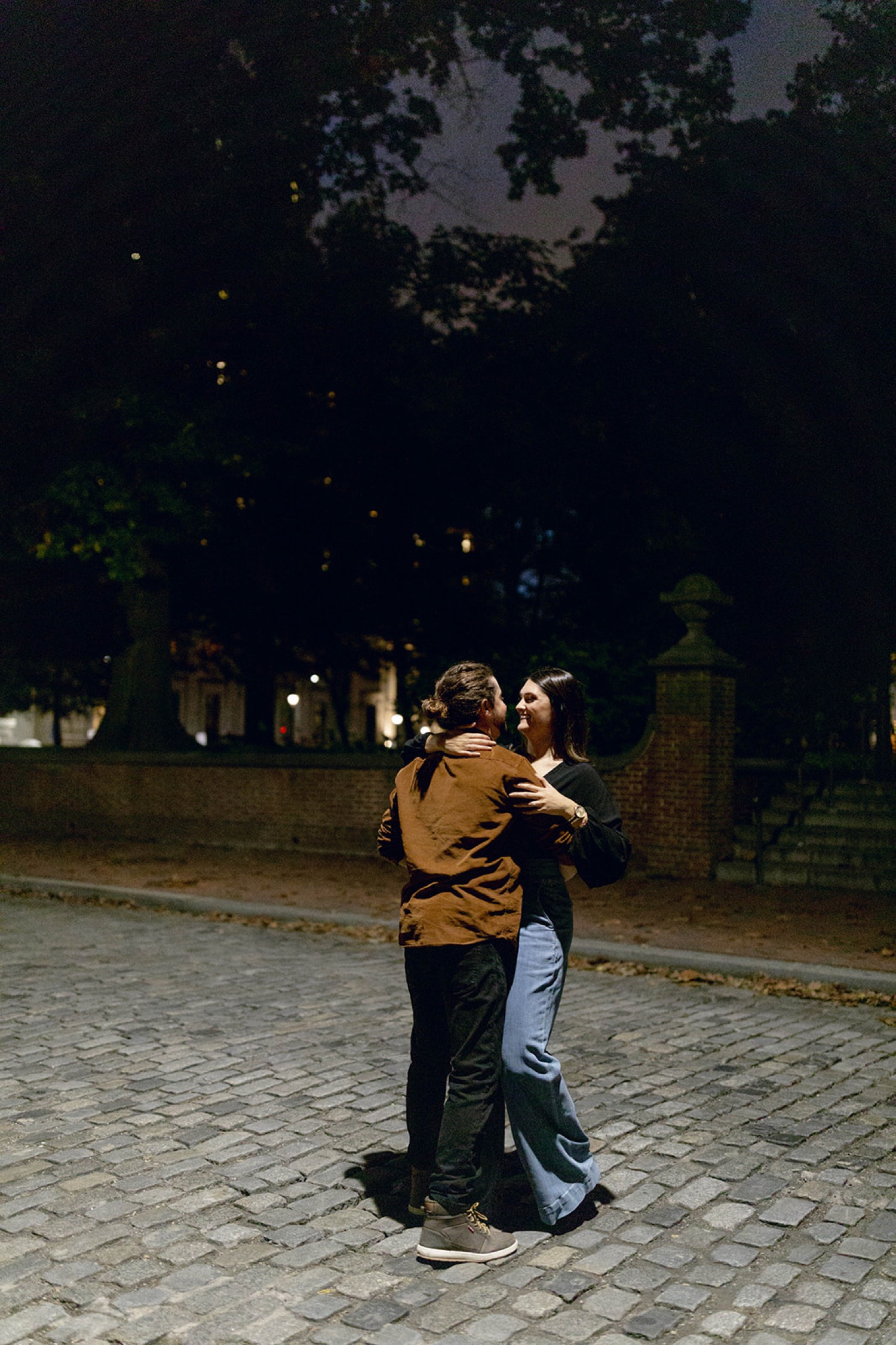 couple dancing together on cobblestone streets