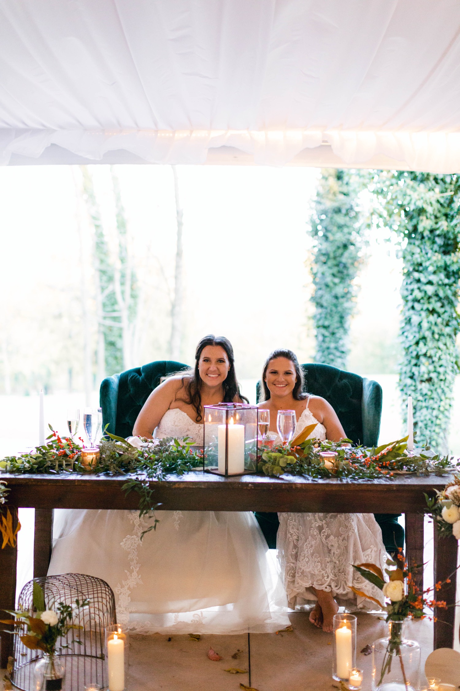 brides at fall inspired head table with teal chairs