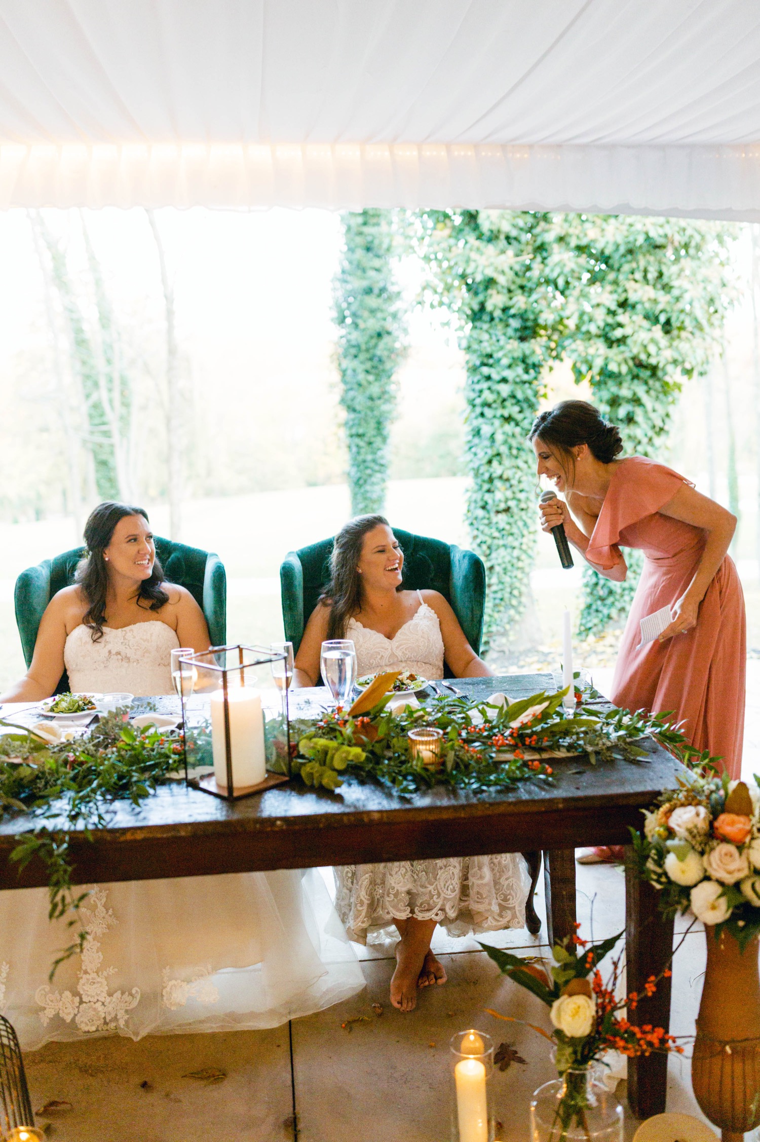 brides listening to toast speech at fall wedding