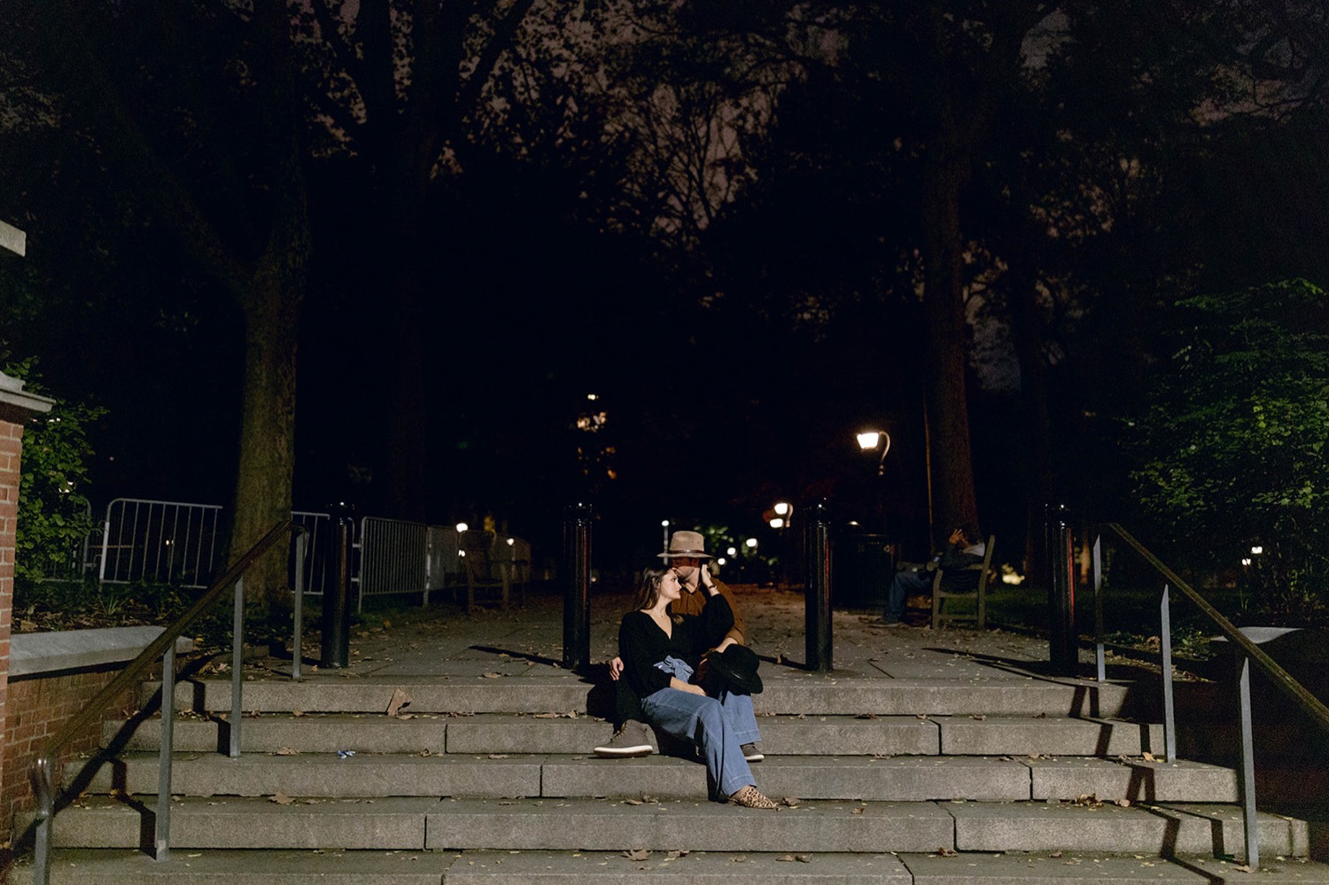 couple sitting on stairs in downtown park