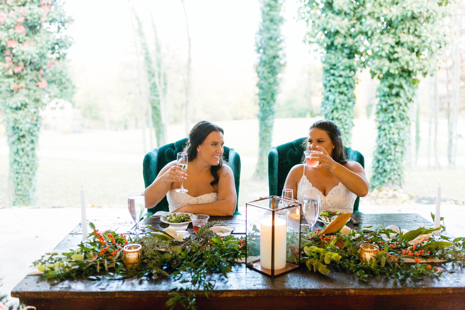 brides drinking at fall wedding head table