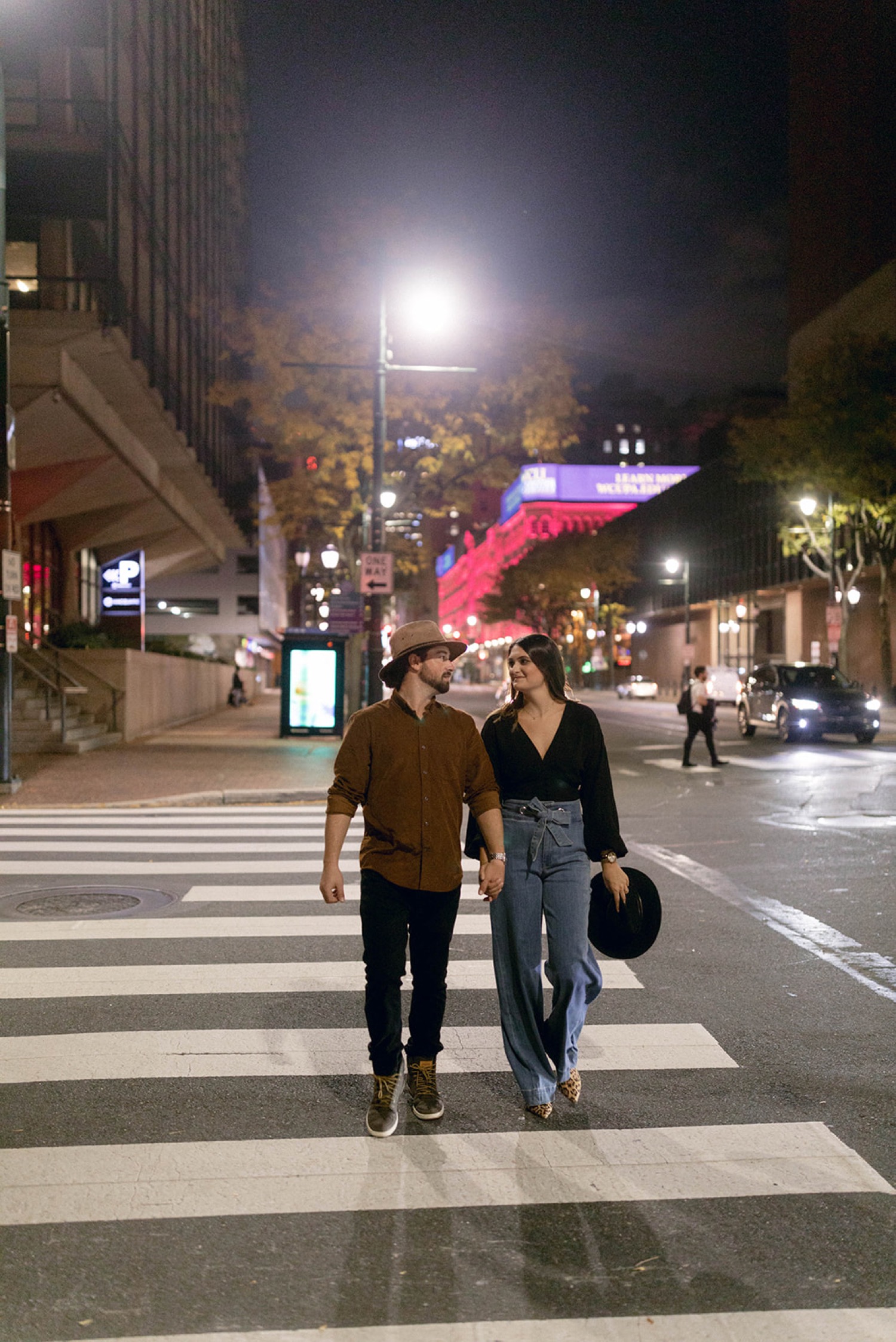 couple walking across street downtown