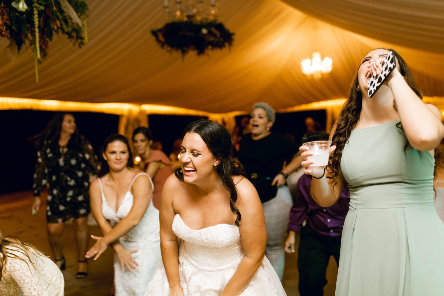 brides dancing and laughing at wedding reception