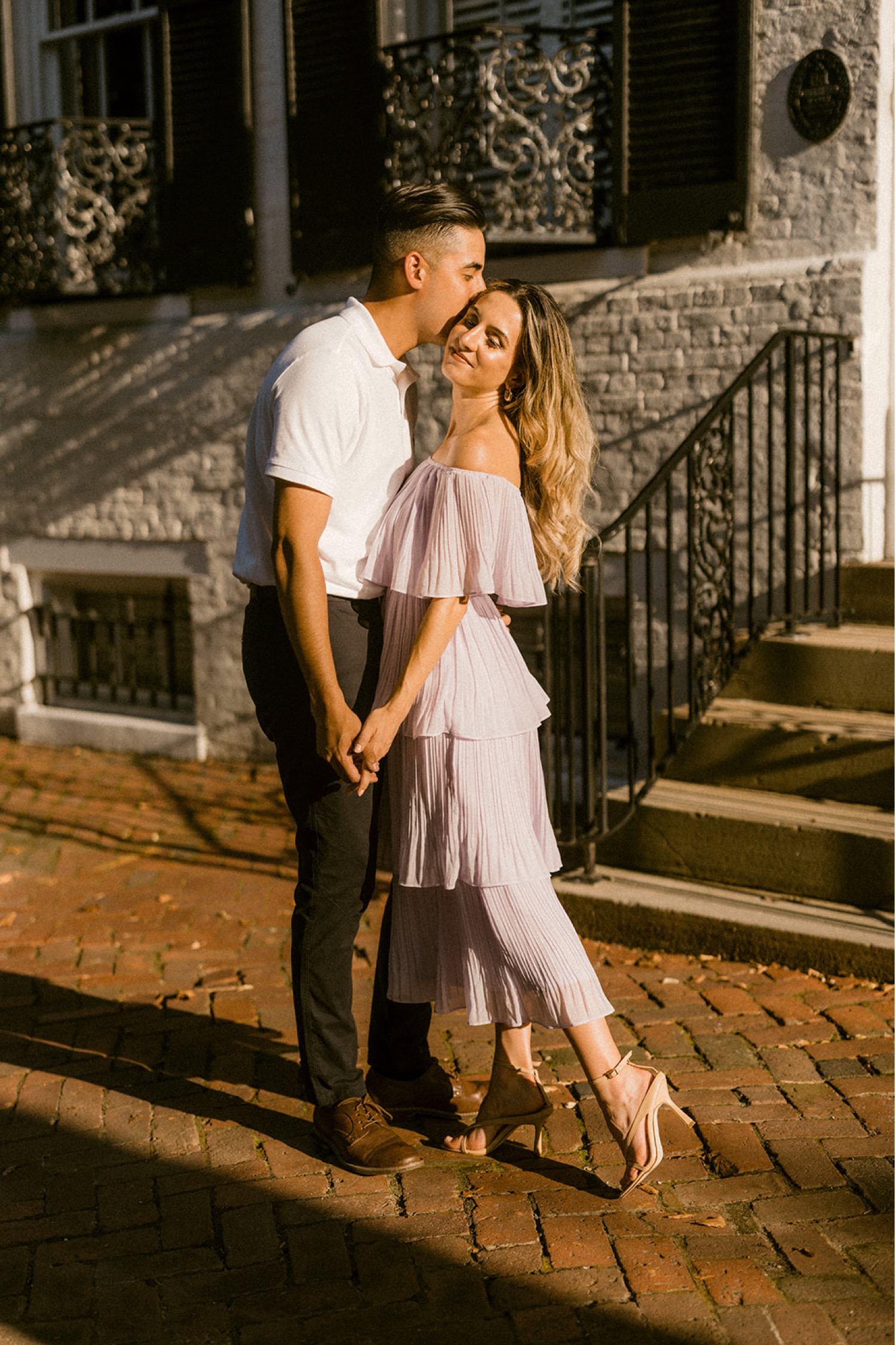 couple kissing on brick sidewalks timeless engagement session
