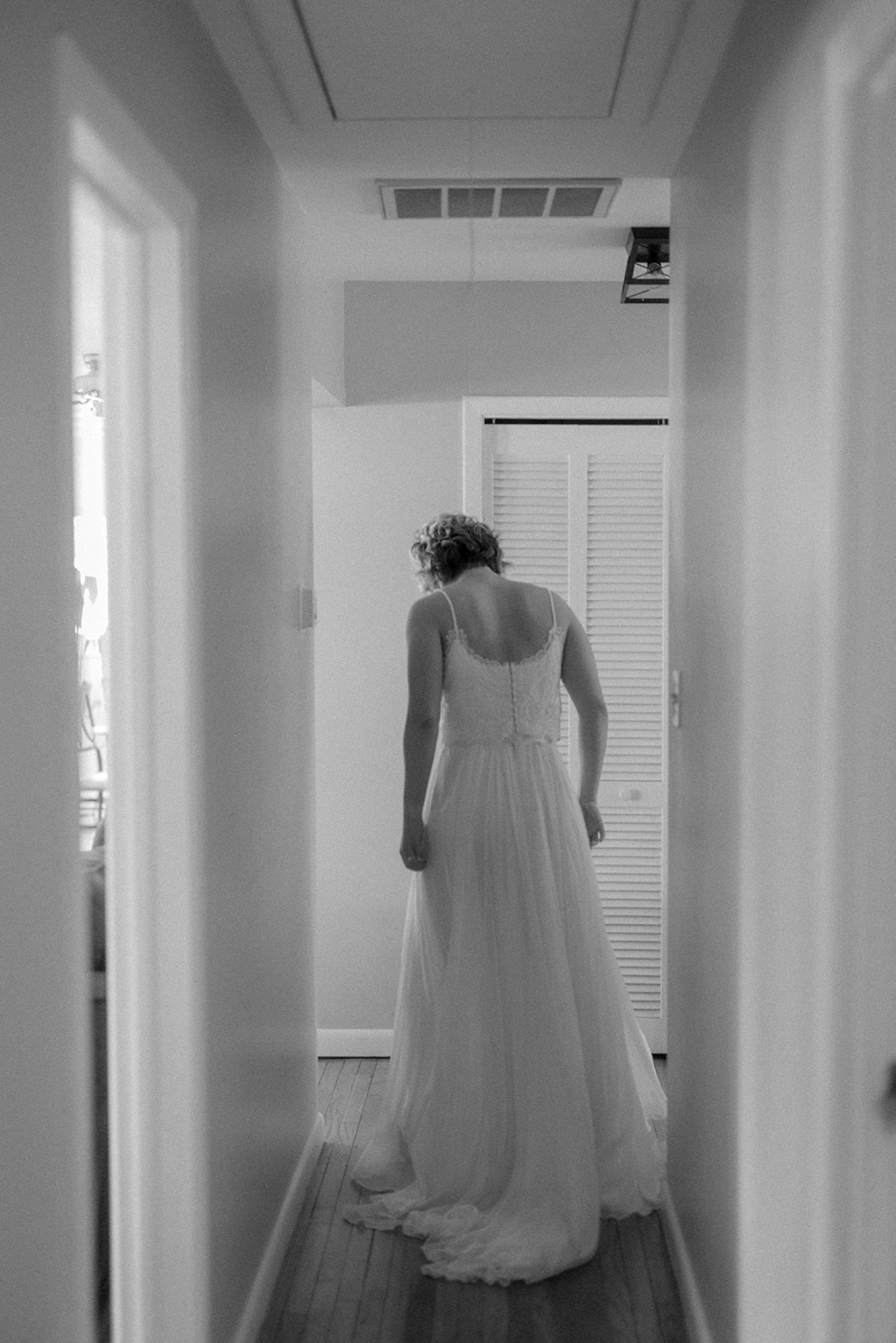 black and white bride walking towards first look in wedding dress