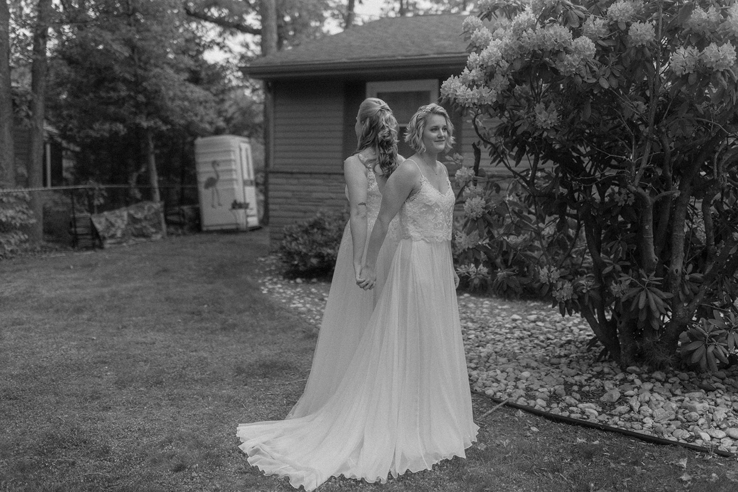 black and white brides holding hands before first look backyard micro wedding