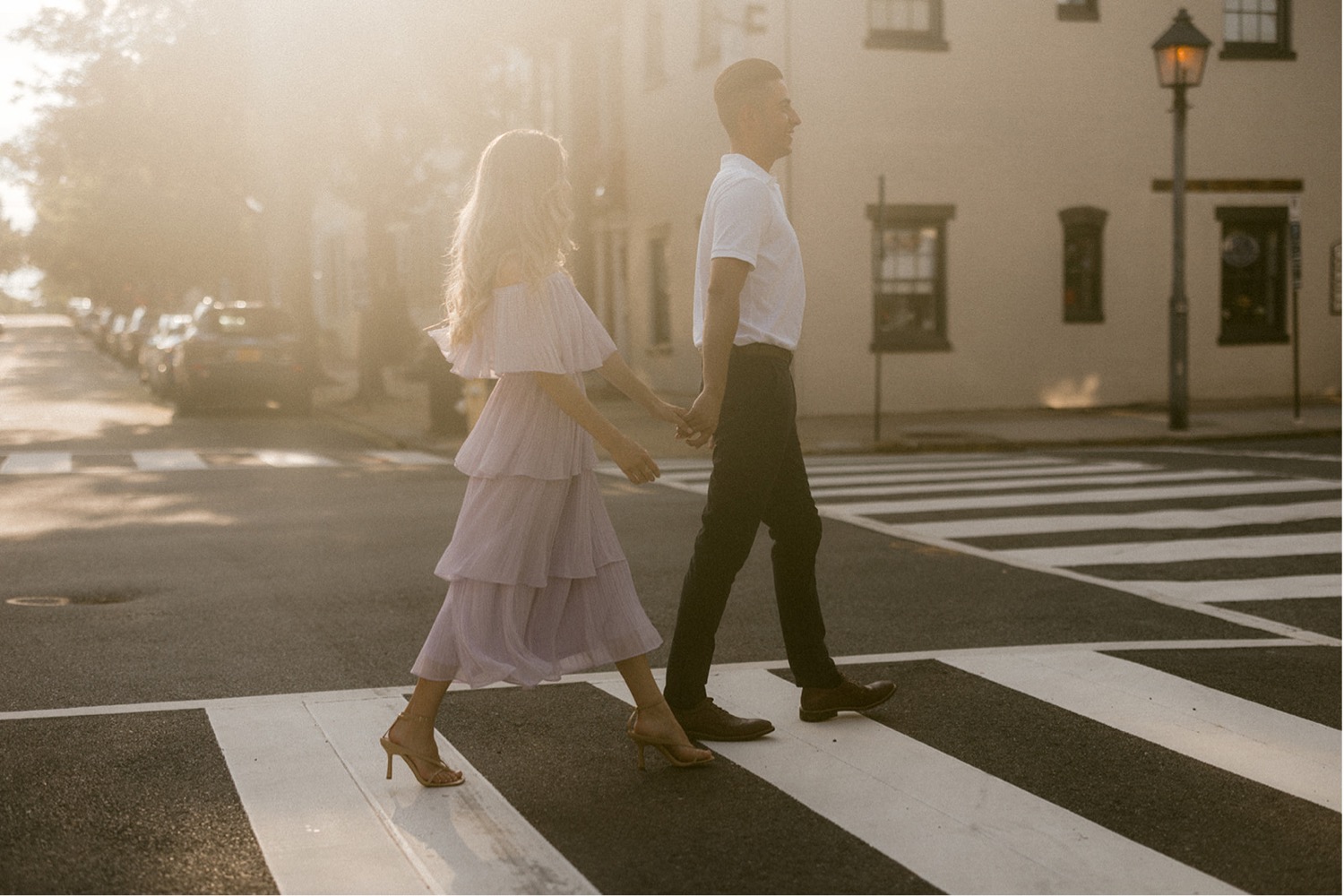 couple walking in crosswalk engagement session