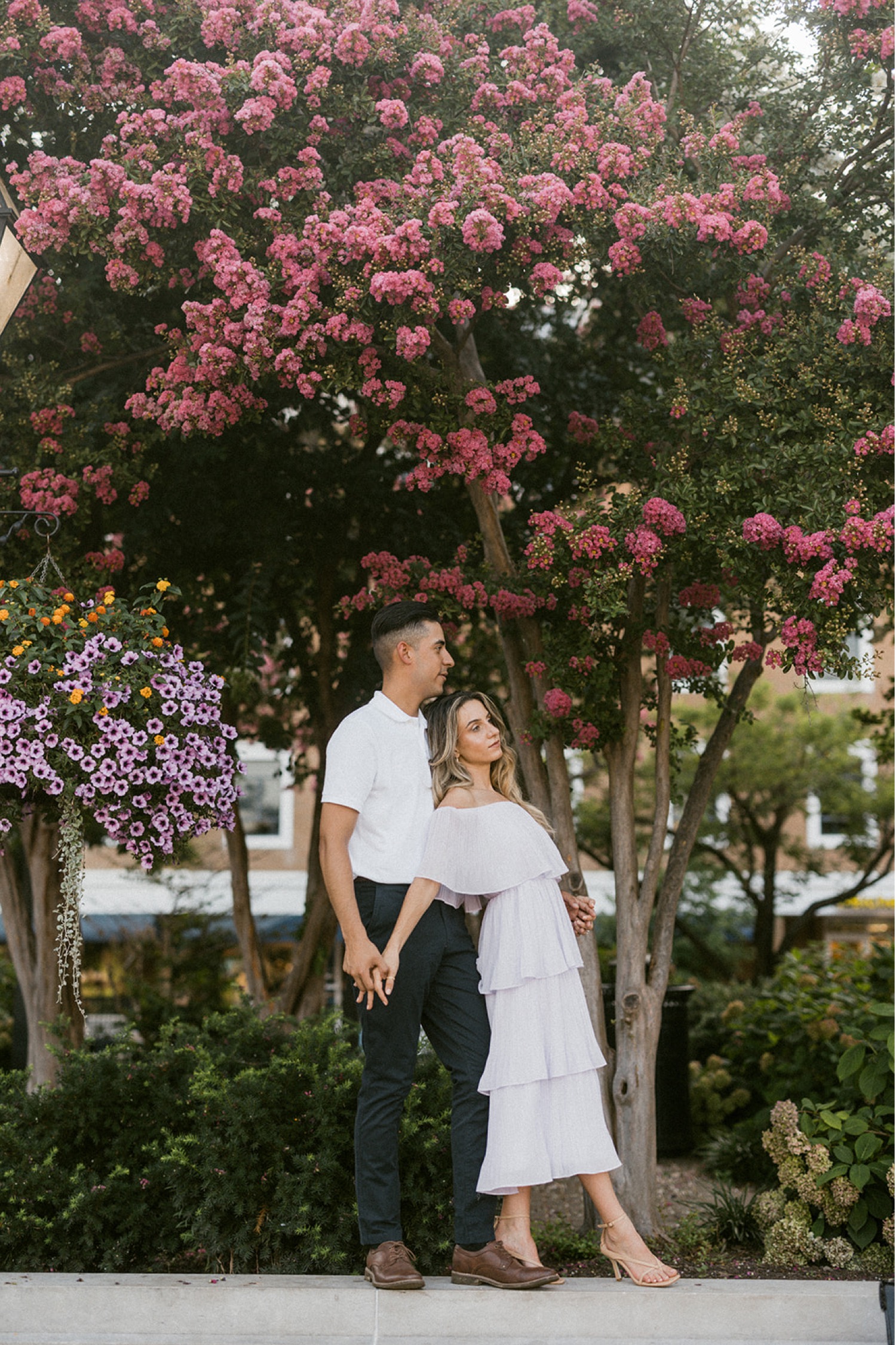 couple standing in front of flowering trees washington dc engagement session