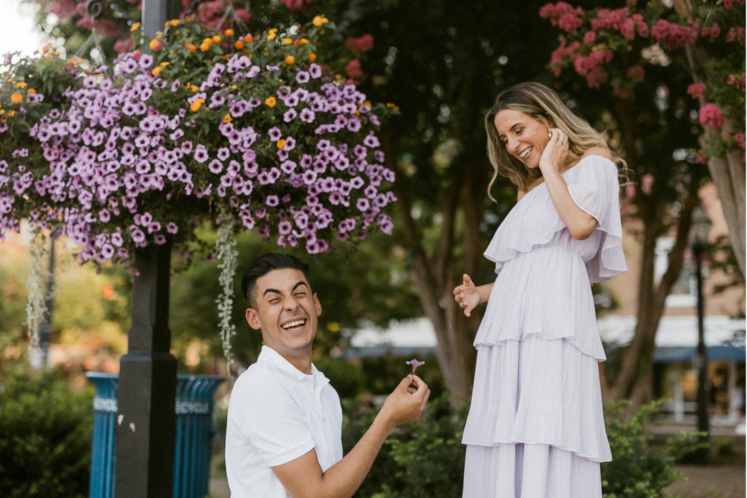 laughing holding flower engagement