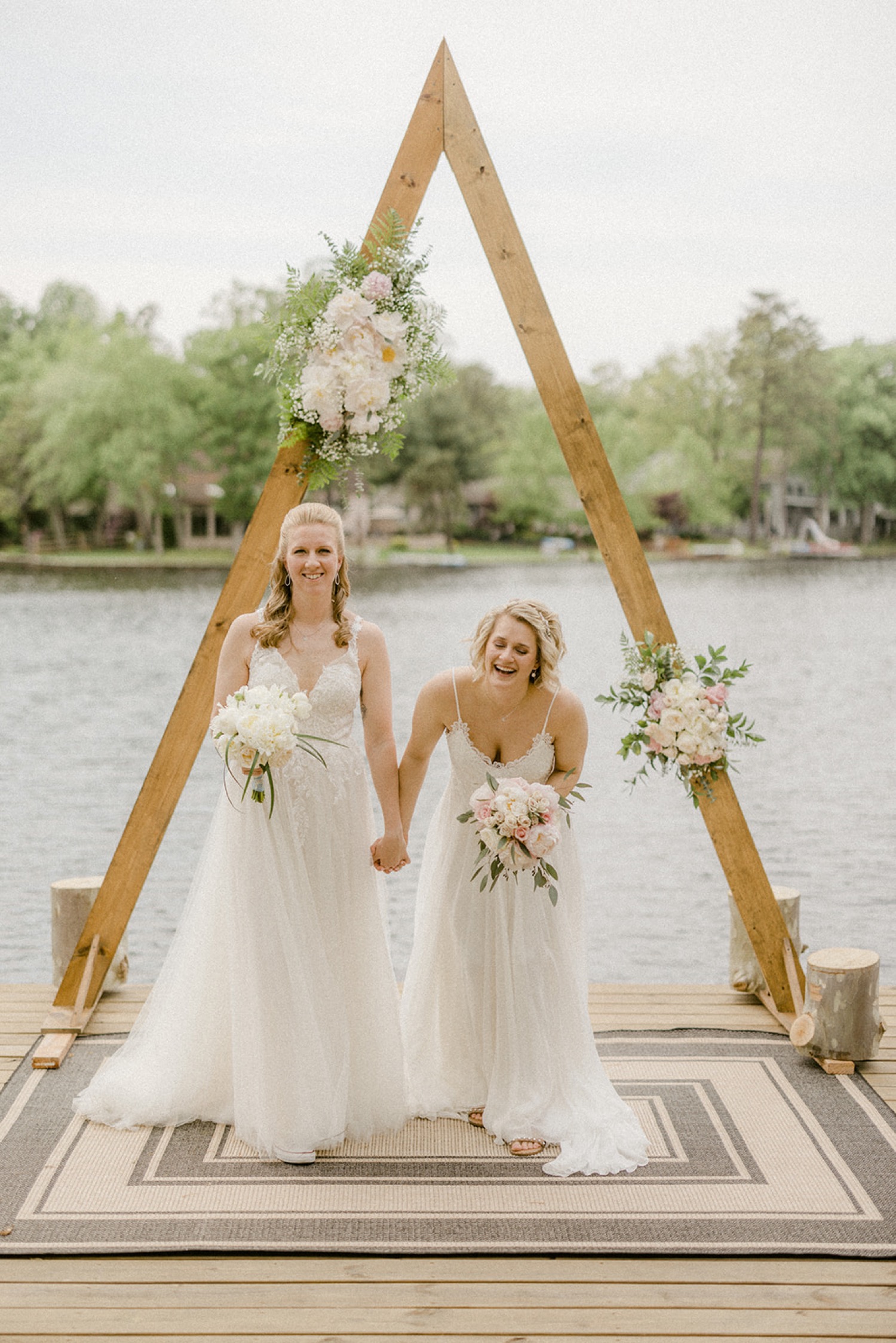 brides laughing in front of arbor lakeside micro wedding