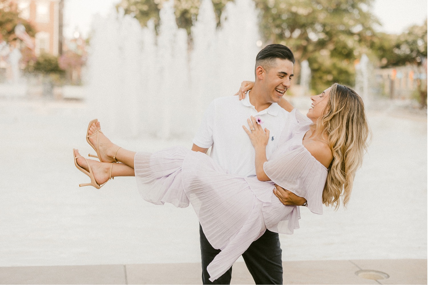 carrying girl in front of fountain washington dc engagement session
