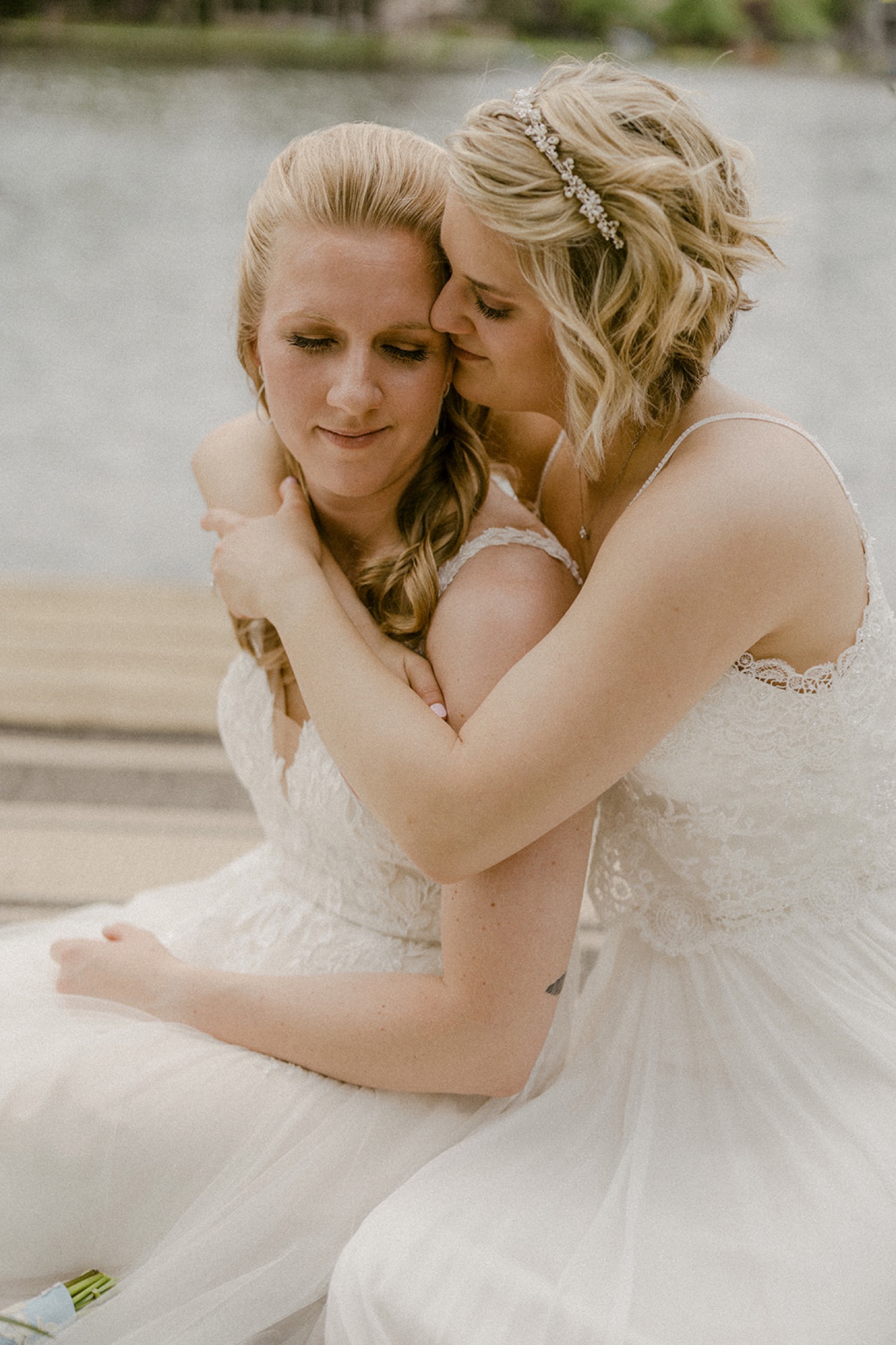 brides intimate hug on dock lakeside backyard micro wedding