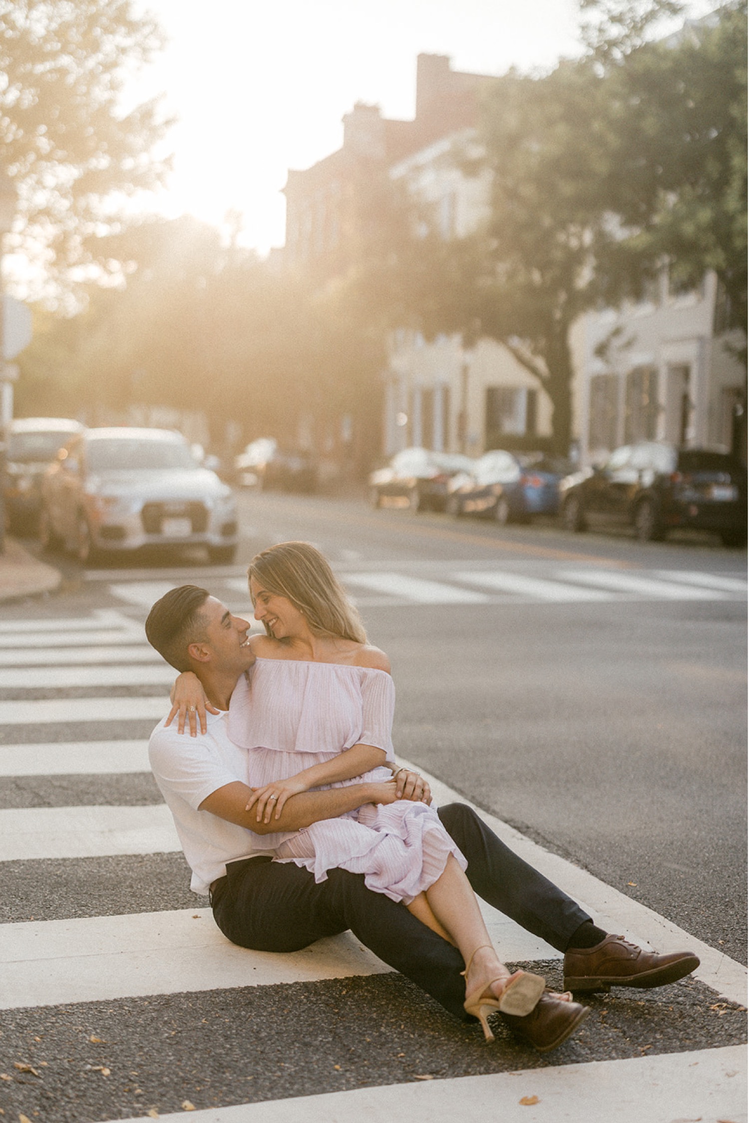 couple sitting in crosswalk street