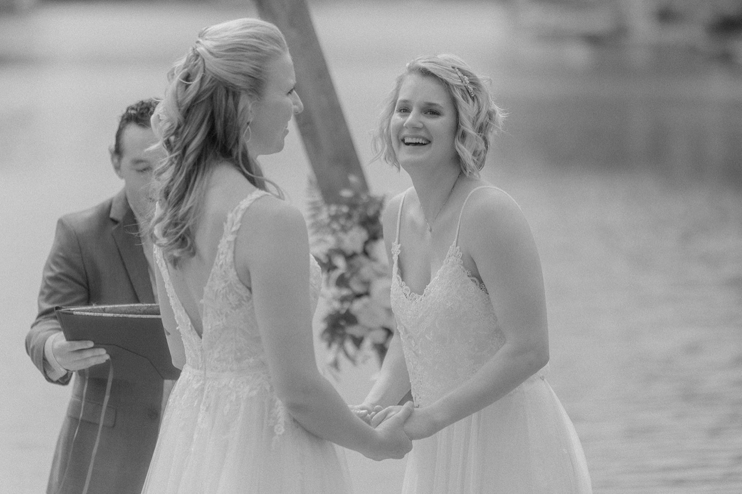 brides holding hands laughing during ceremony wedding