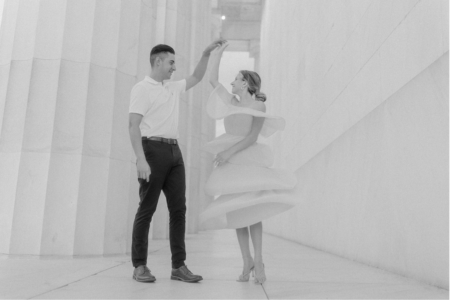 couple dancing beside pillars washington dc engagement session
