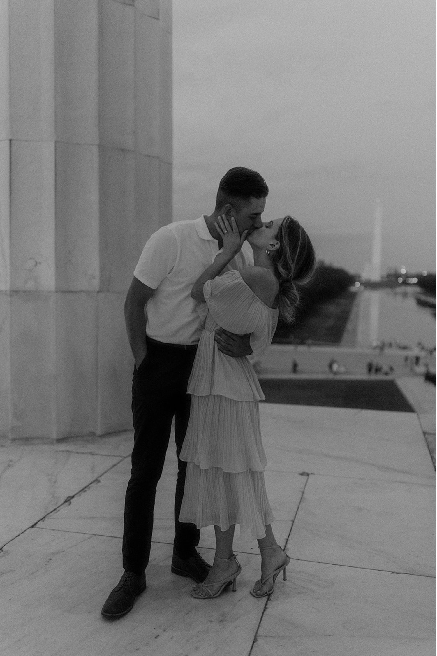 couple kissing with monument in background washington dc engagement session
