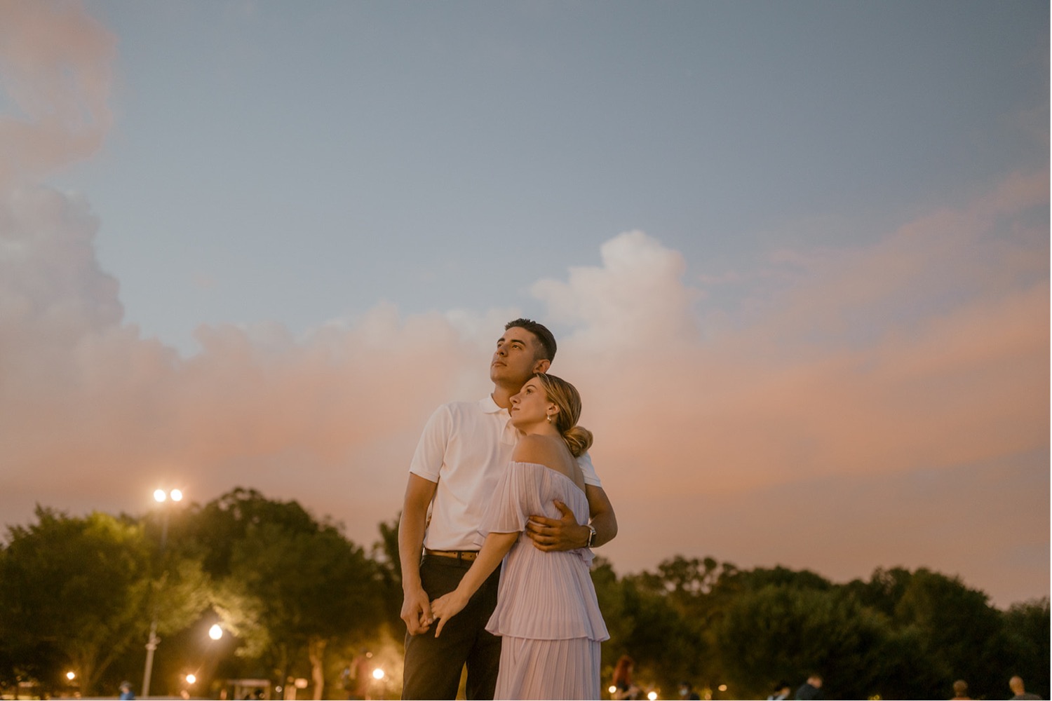 couple looking off into distance sunset sky pink clouds timeless washington dc engagement session