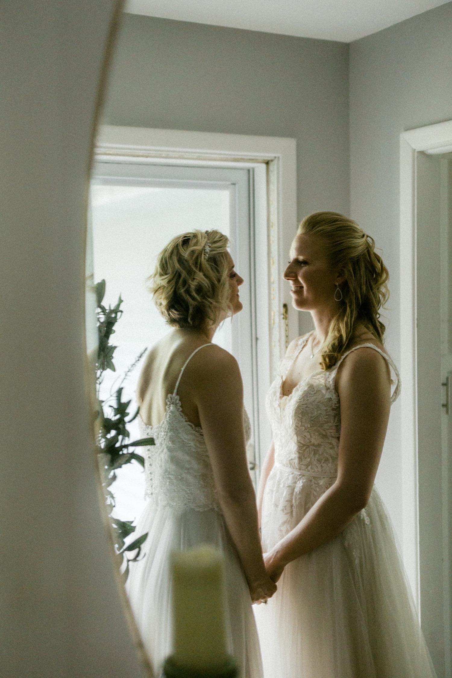 brides holding hands couple portrait mirror reflection