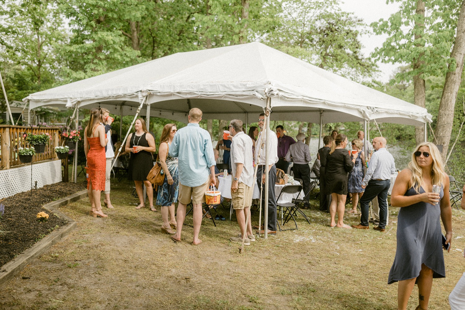 guests under tent during backyard micro wedding reception