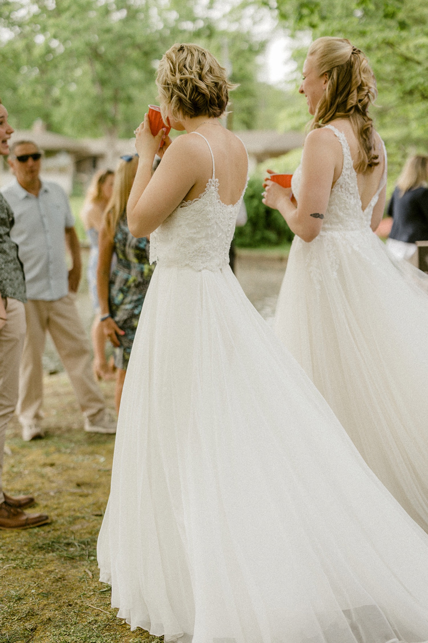 brides walking into backyard micro wedding reception