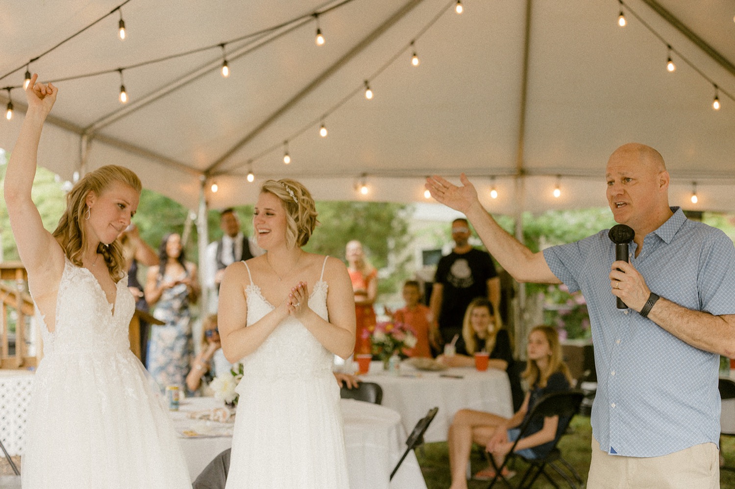 brides clapping in reaction to dad speech backyard micro wedding