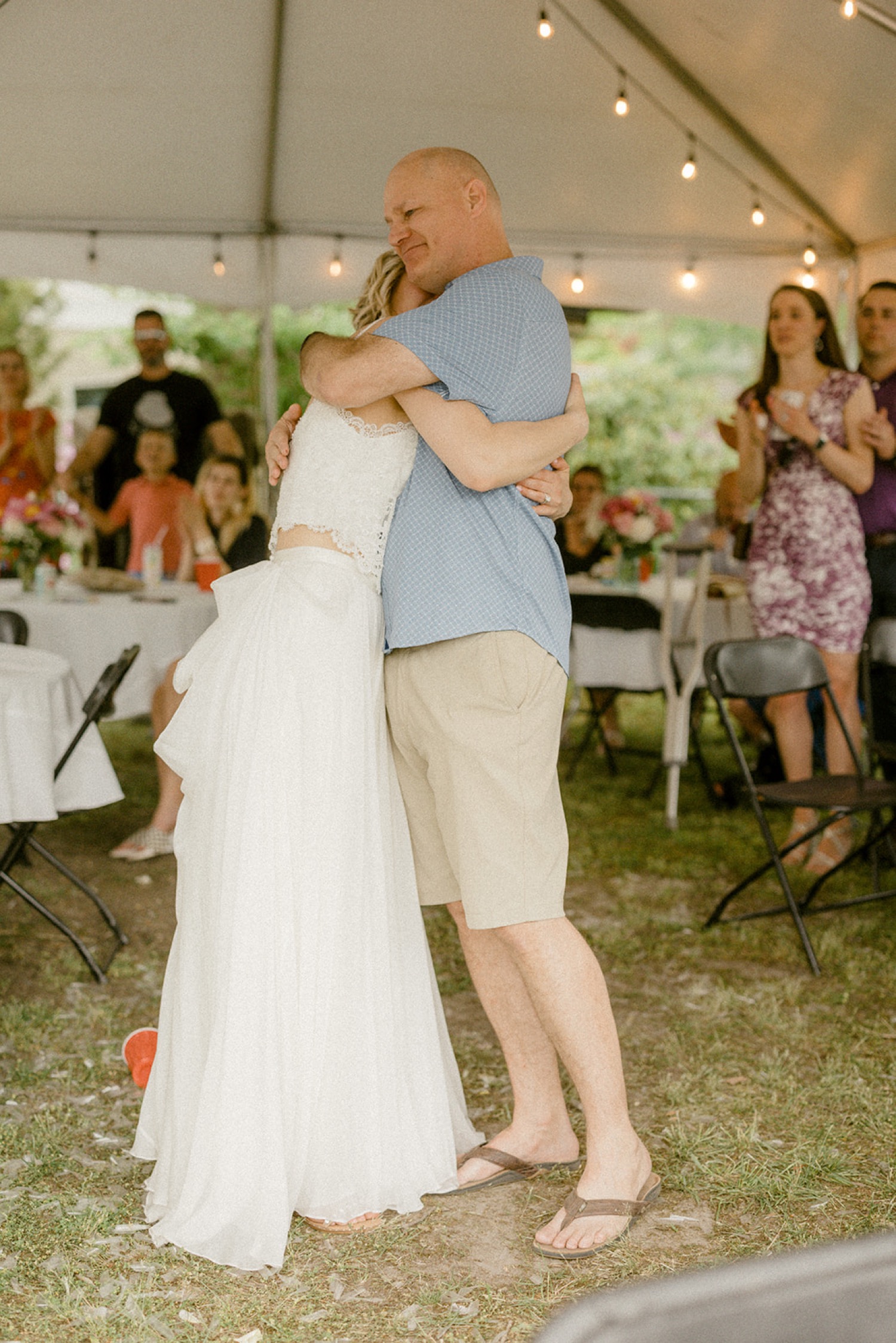 bride hugging emotional crying father after speech in backyard micro wedding