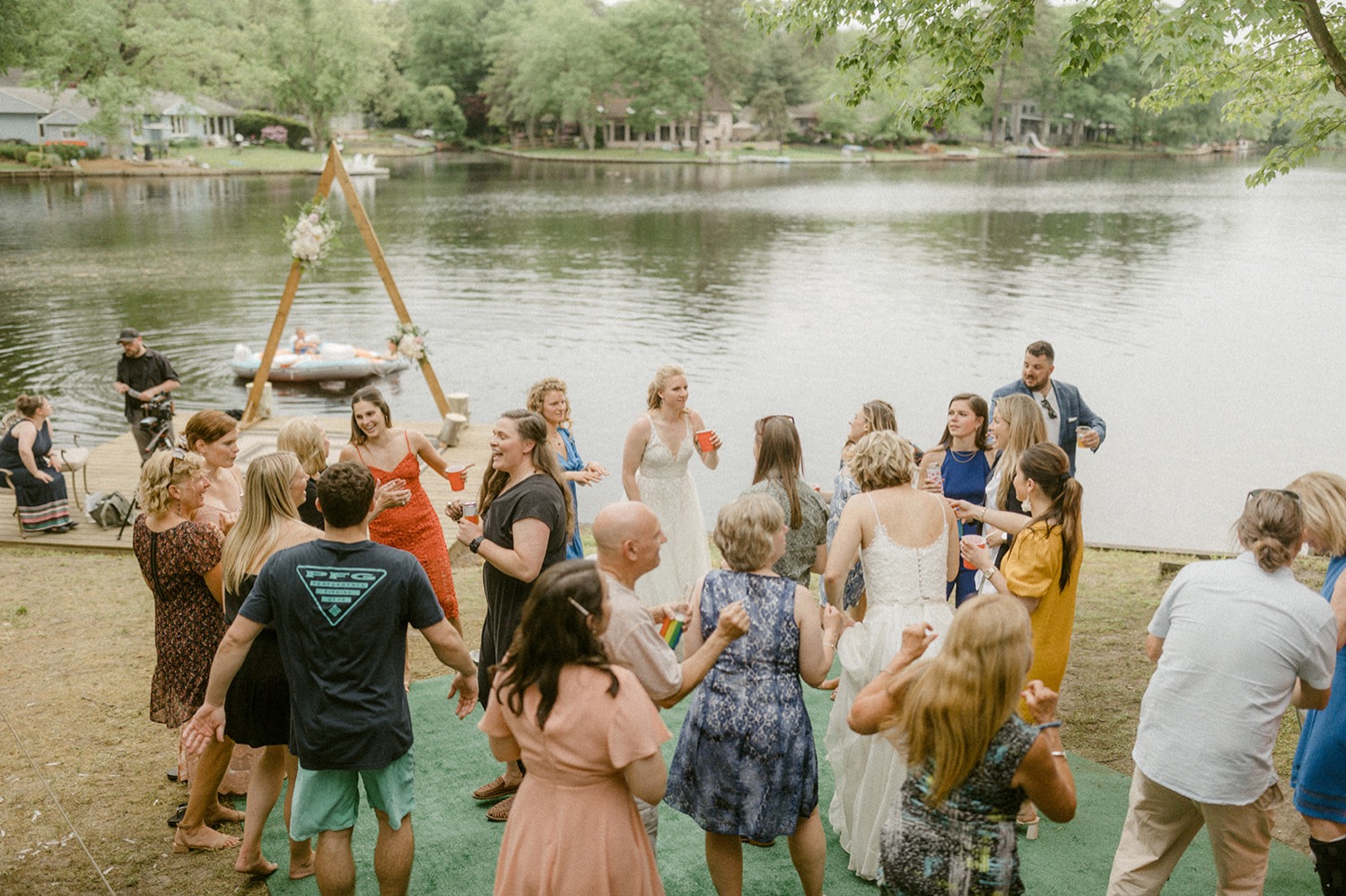 guests dancing during reception lakeside backyard micro wedding