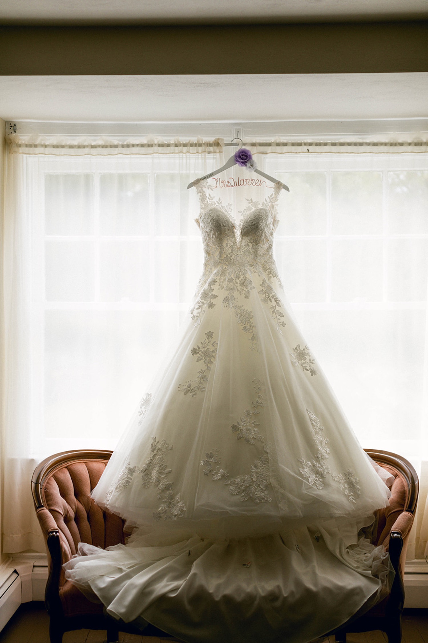 bride wedding dress hanging in window