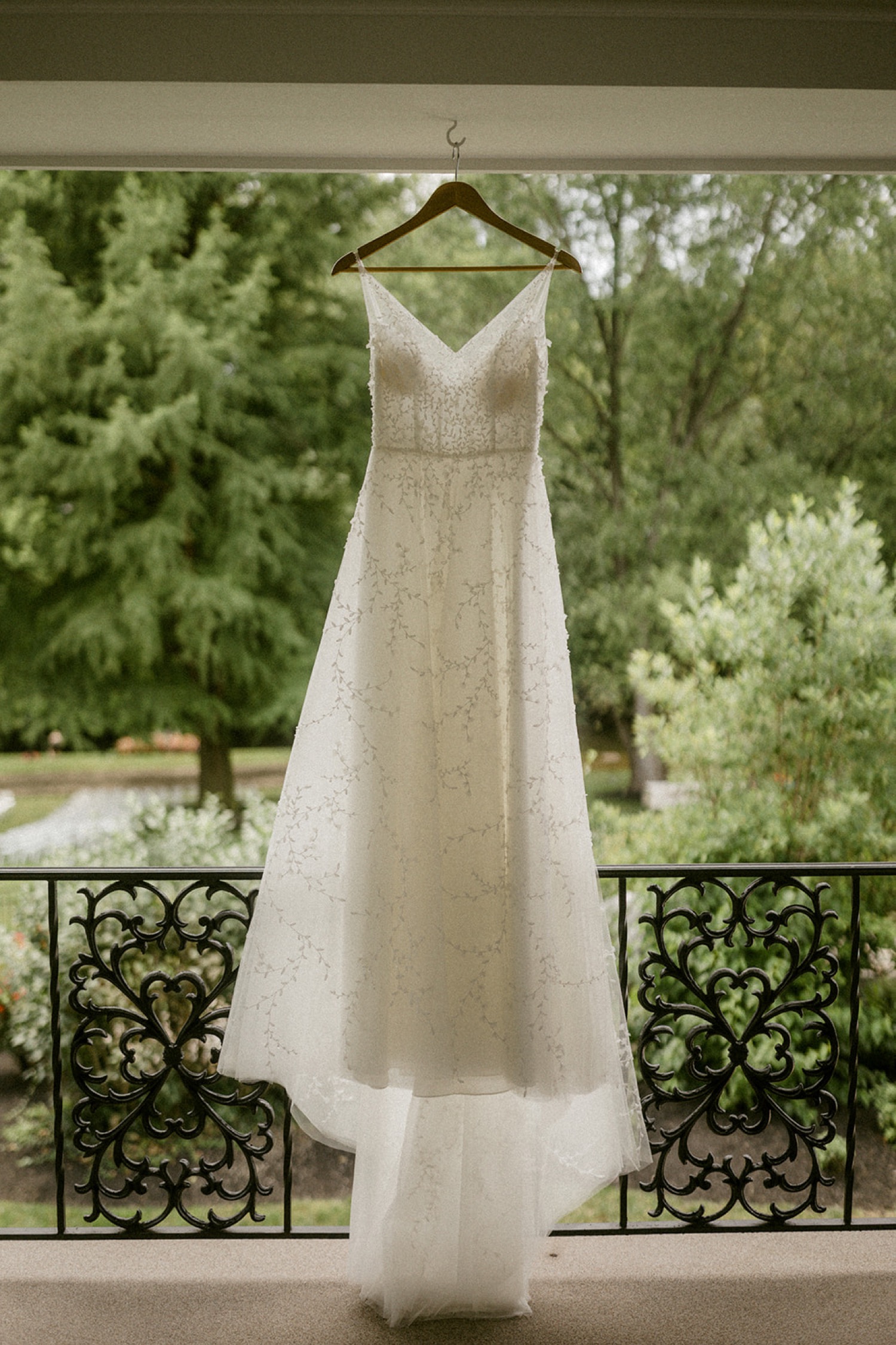 wedding dress hanging outside on hanger