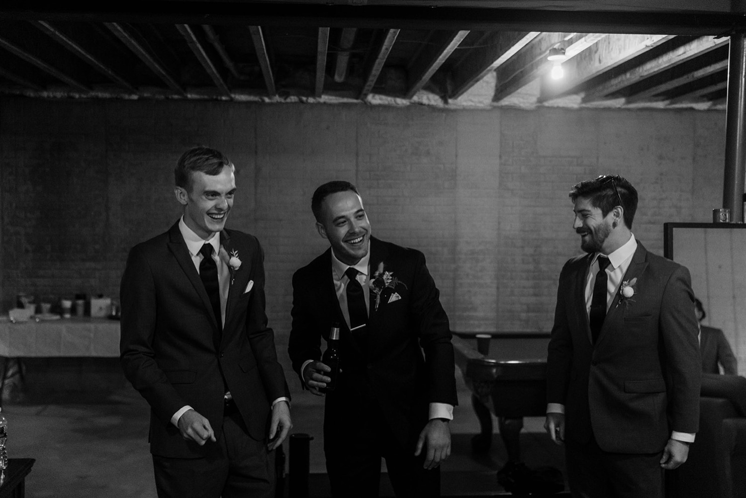 groomsmen laughing getting ready for wedding