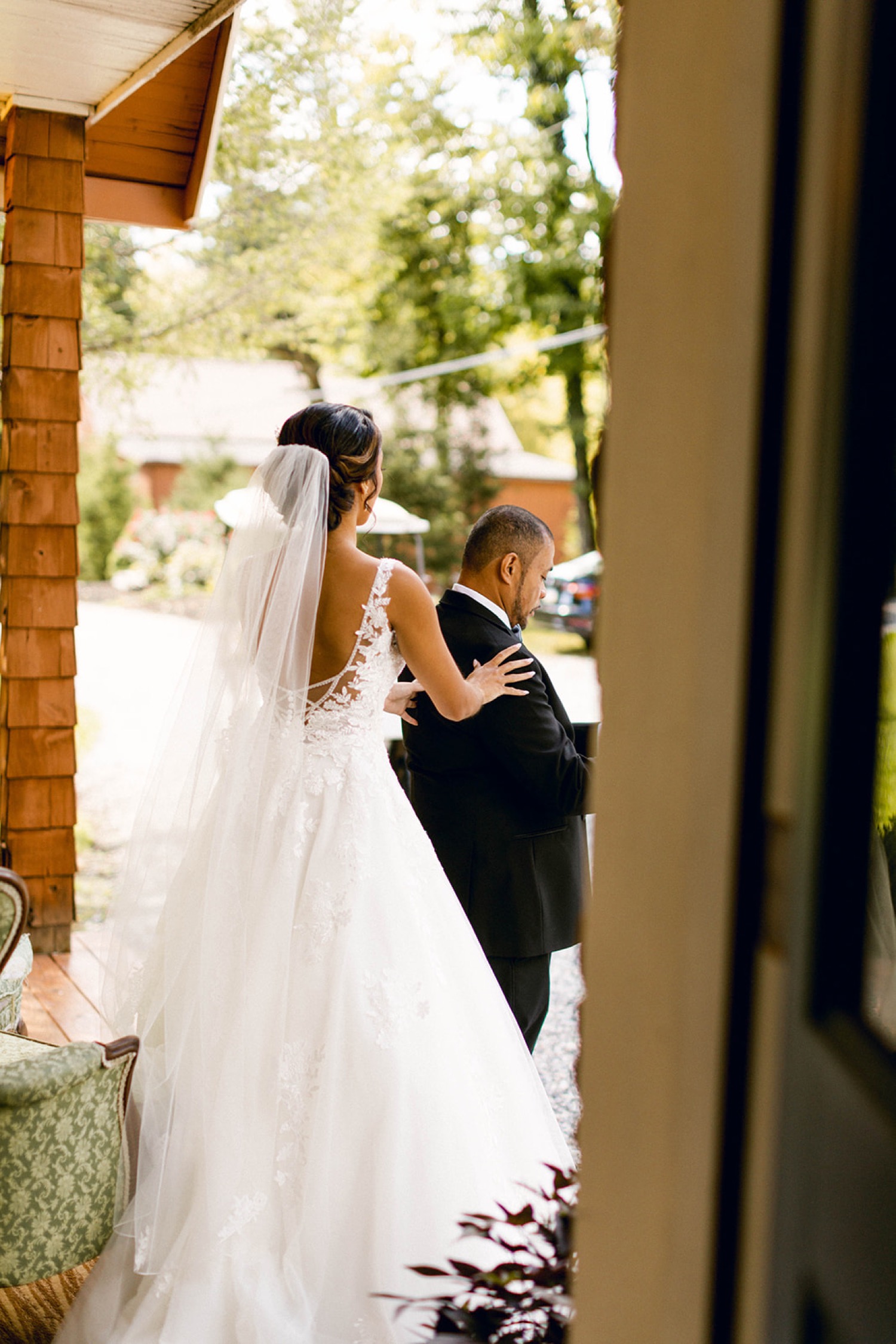 bride walking through doorway first look with father
