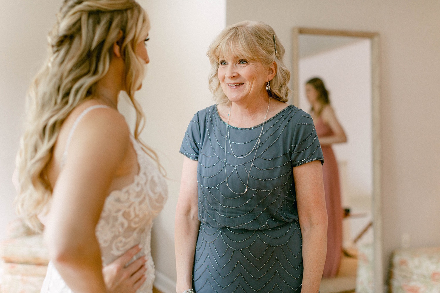 mother of the bride smiling first look